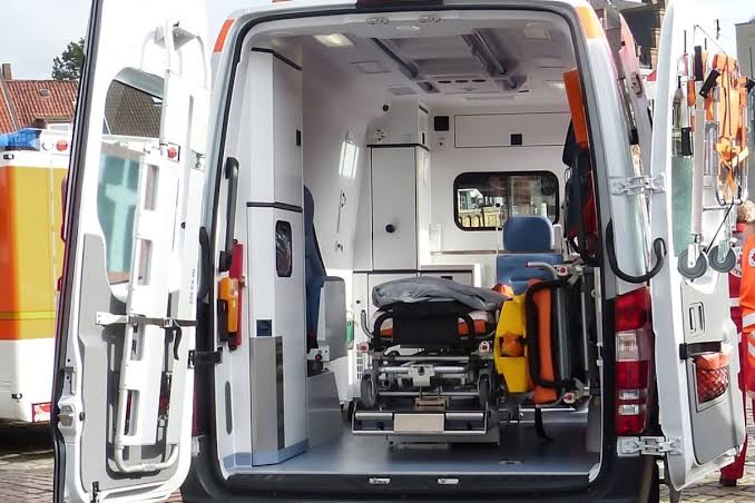 A van with the door open and ramp in it.